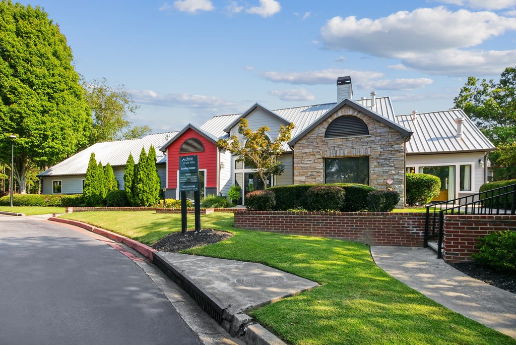 A house with a red door and a sign in front of it.